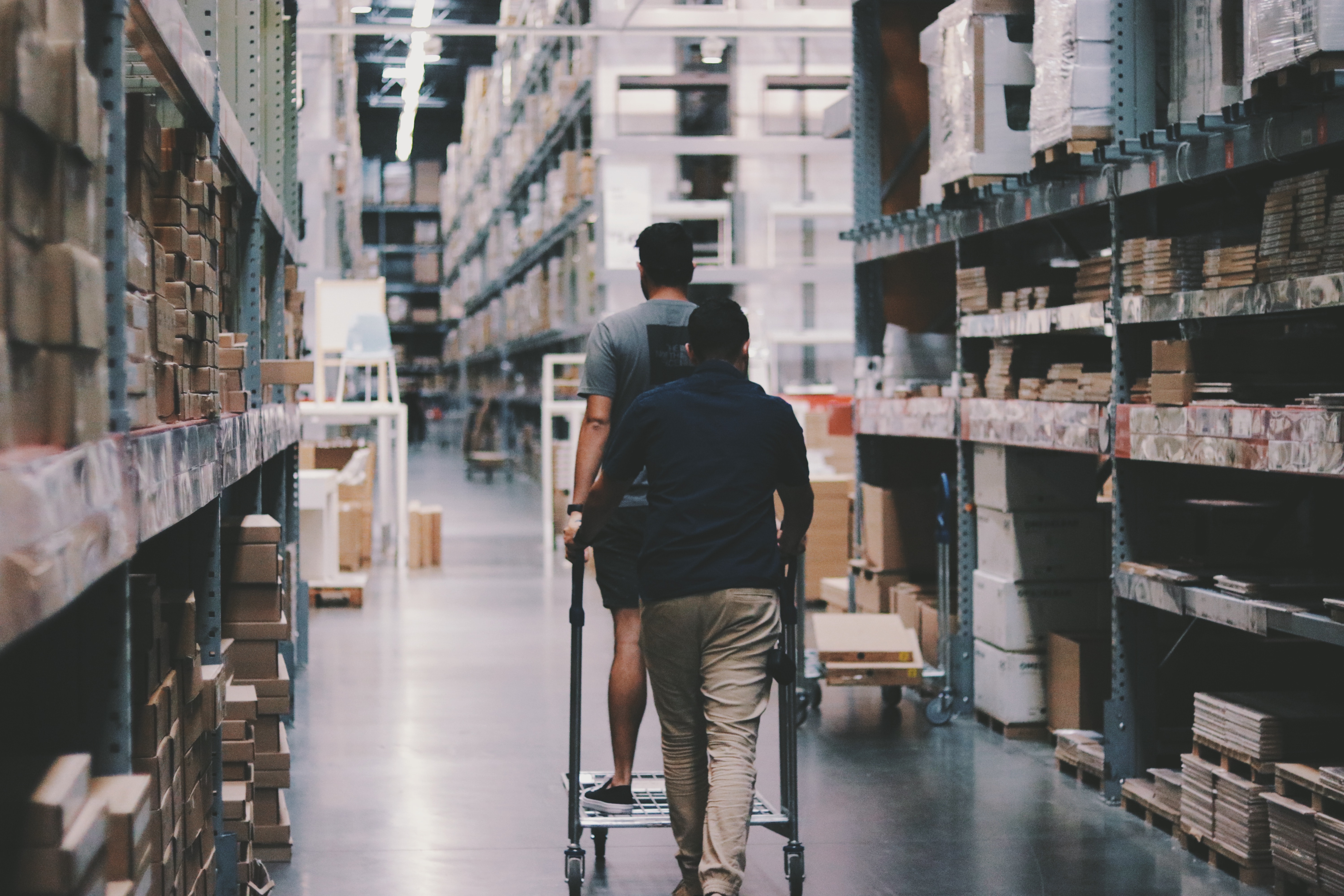 Business Owners Stocking Shelves After Purchasing Extra Stock with an Inventory Loan