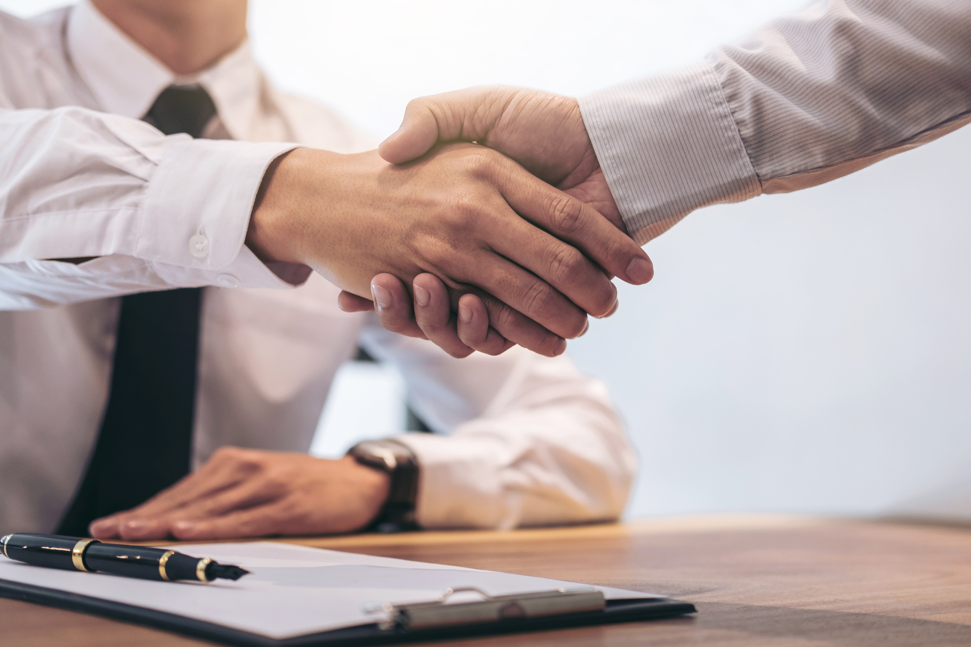 Businessmen finalizing an asset-based commercial real estate loan